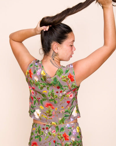 Women's Mohala Cropped Vest featuring botanical illustrations of native Hawaiian flowers. Soft and comfortable bamboo fiber rayon. Sleeveless button-down top. Poi (purple) color.